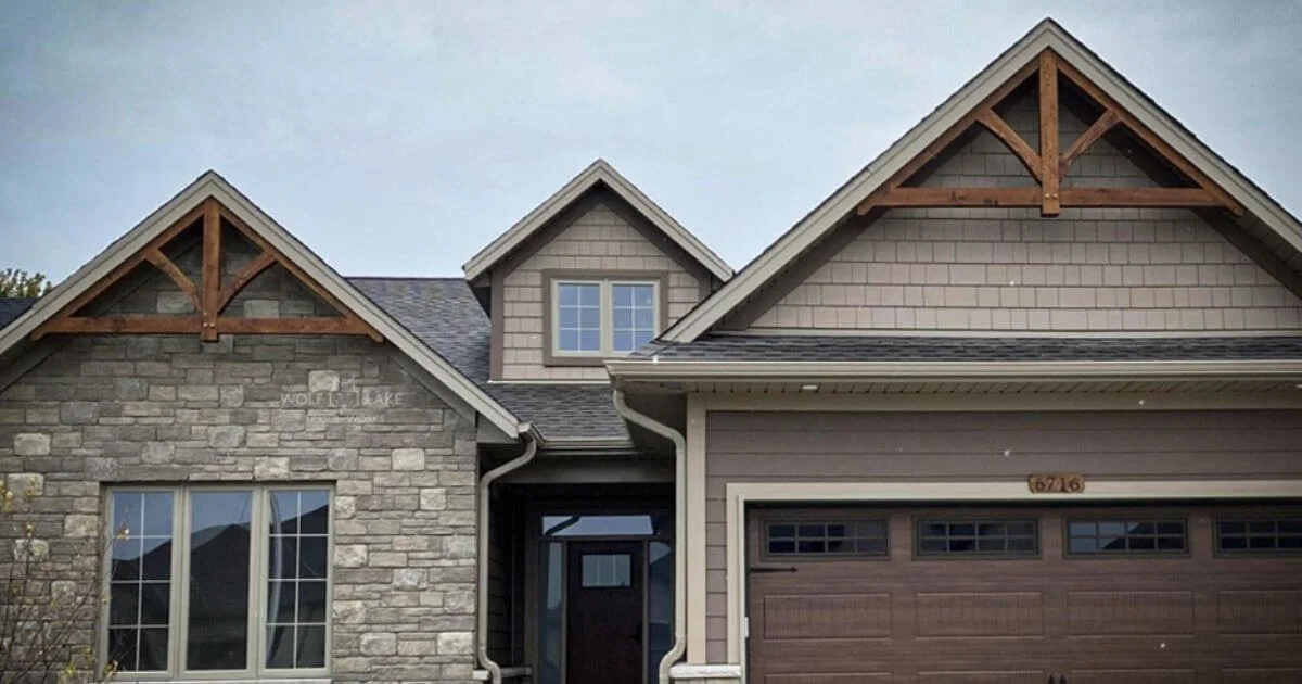 Decorative timber gable trusses on modern home exterior.